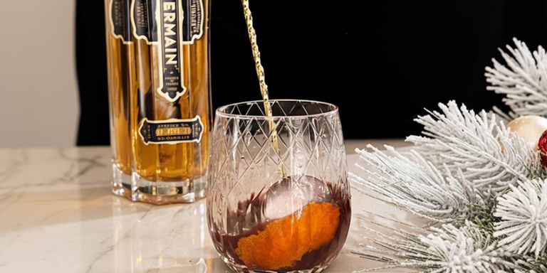 Elegant autumn cocktail setup with sparkling glassware and warm fall lighting on decorated table