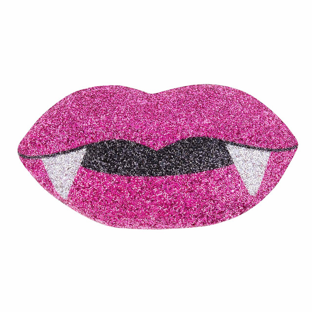 Pink glittery lips shaped pillow with black fangs featuring a shiny texture and a sparkling finish.