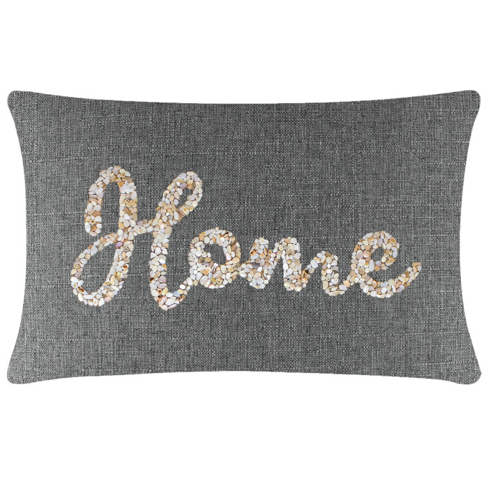 Rectangular gray pillow with a textured fabric featuring a seashell design spelling "Home" in beige and white tones.