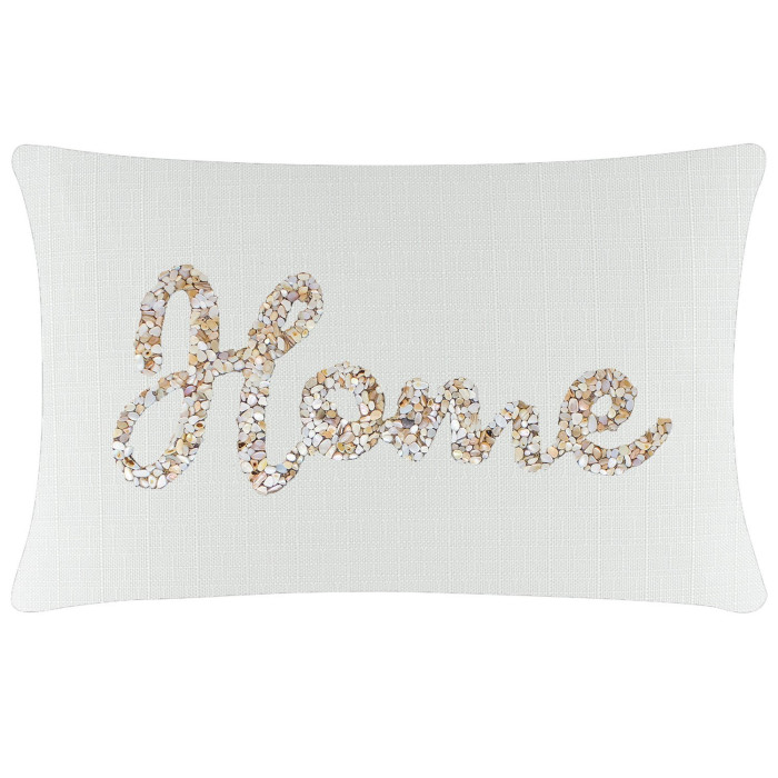 White rectangular pillow with a textured fabric featuring a seashell design spelling "Home" in beige and cream tones.