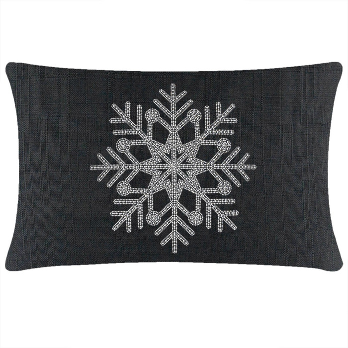 Black rectangular pillow featuring a rhinestone snowflake design on a textured surface.