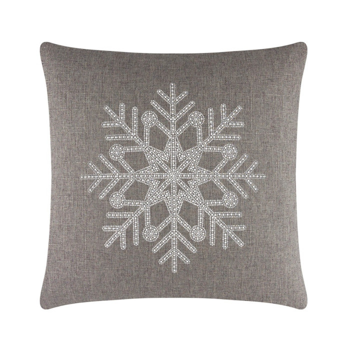 Square brown pillow featuring a rhinestone snowflake design on a textured fabric surface.