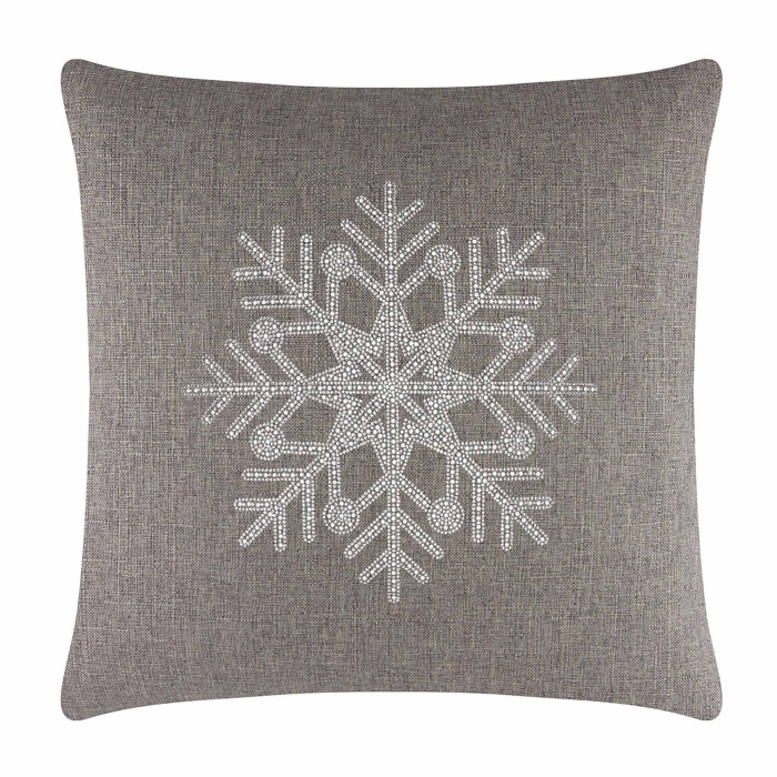 Square brown pillow featuring a rhinestone snowflake design on a textured fabric surface.