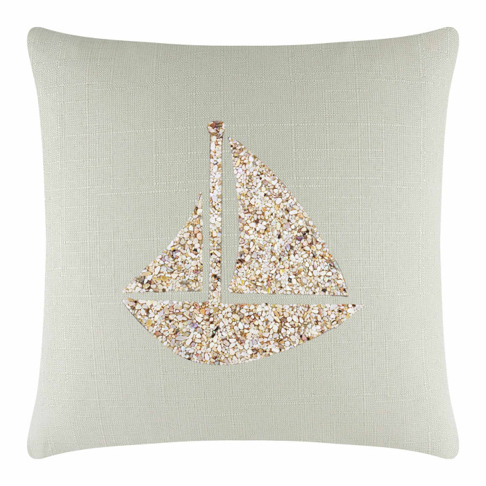 Square pillow with a light green linen cover featuring a textured seashell sailboat in beige and white embellishments.