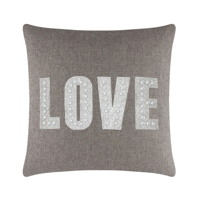 Square brown pillow featuring the word "LOVE" in rhinestones and faux pearls on a textured fabric background.