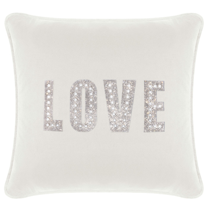 White velvet pillow featuring the word "LOVE" embellished with rhinestones and faux pearls.