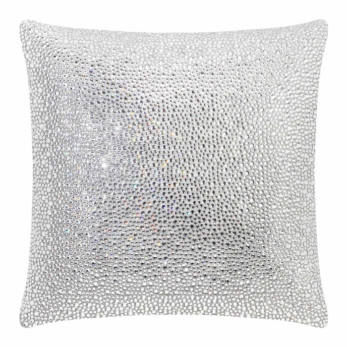 Square pillow covered in shimmering silver rhinestones on a soft velvet texture.