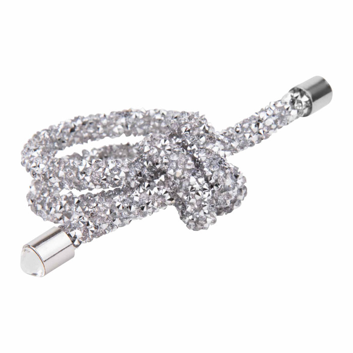 Silver wire napkin ring shaped as a knot embellished with small rhinestones featuring smooth metallic ends.