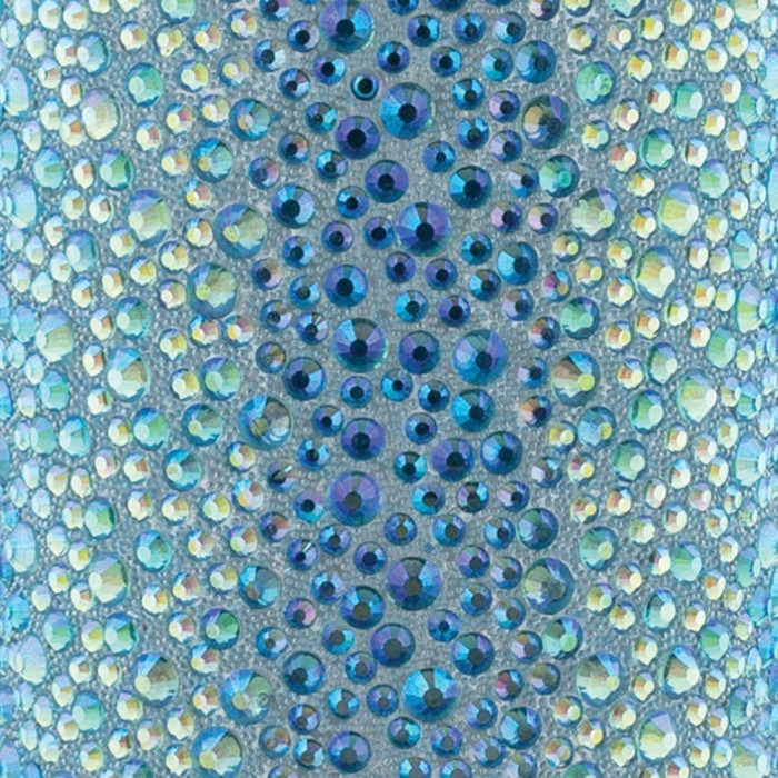 Aqua iridescent surface with various sizes of blue and green rhinestones featuring a sparkling texture and reflective quality.
