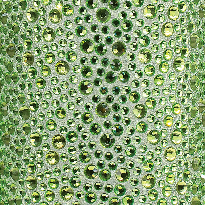 Lime green rhinestones in various sizes arranged on a textured silver background with intricate detailing.