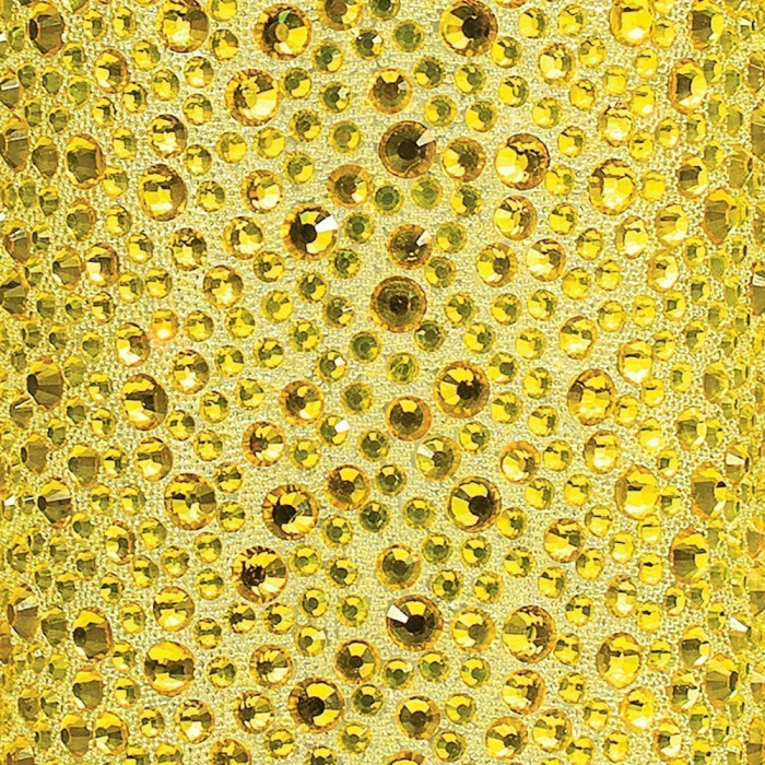 Yellow fabric with various sizes of yellow and light green rhinestones featuring a shiny faceted surface and a textured background.