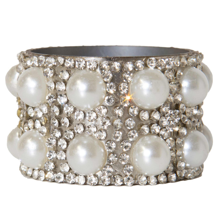 Stainless steel napkin ring adorned with faux pearls and clear rhinestones cylindrical shape shiny texture 1.5" diameter.