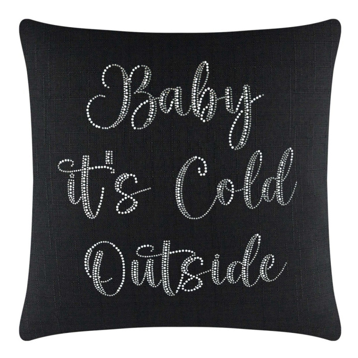 Black pillow with a textured surface featuring glass rhinestones spelling "Baby it's Cold Outside" in a cursive font.