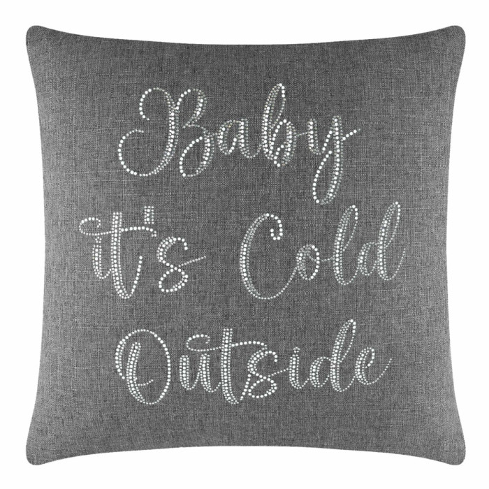 Gray square pillow with glass rhinestones spelling "Baby It's Cold Outside" in a cursive font on a textured fabric surface.