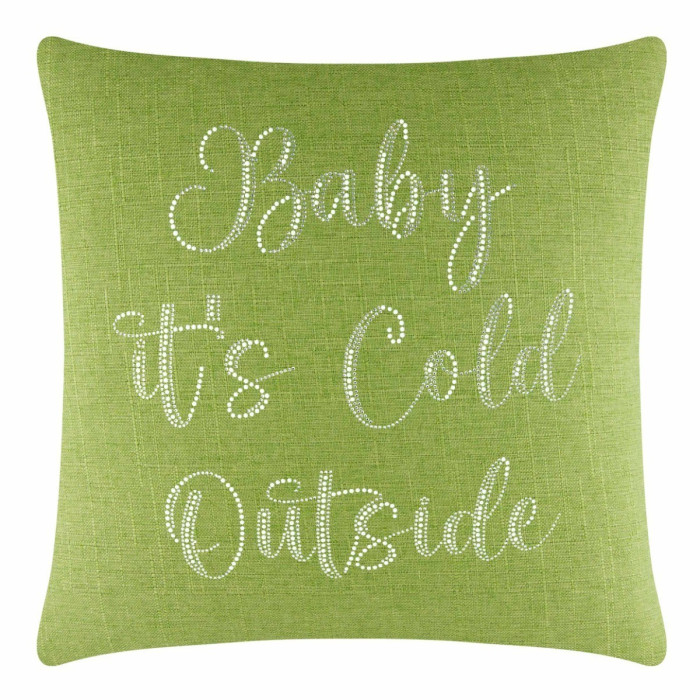 Lime green square pillow with glass rhinestone text "Baby it's Cold Outside" on a textured fabric surface.