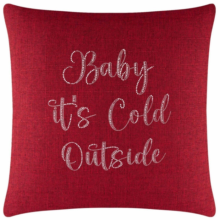 Red textured pillow with white glass rhinestones spelling "Baby it's Cold Outside" in a cursive font.