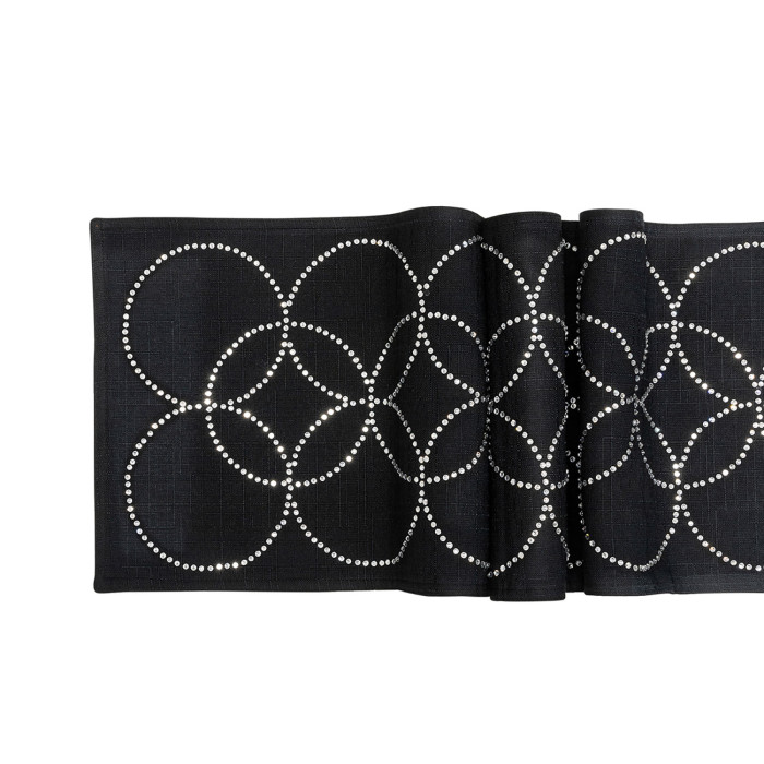 Black table runner with overlapping circles made of glass rhinestones on a textured fabric surface.