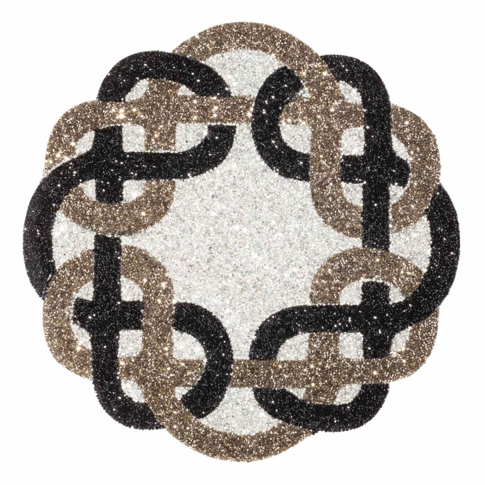 Circular placemat featuring a sparkling Celtic knot design in shades of black silver and gray with a textured surface.