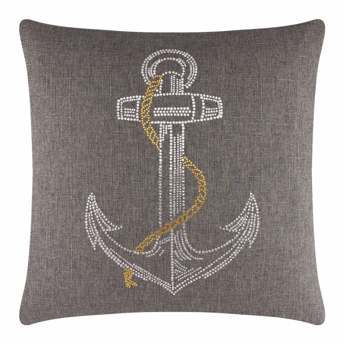 Square brown pillow with a textured surface featuring a rhinestone anchor design in silver and gold tones.