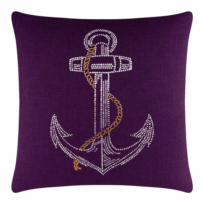 Purple pillow with a rhinestone-embellished white anchor design and a golden rope detail on a textured fabric surface.