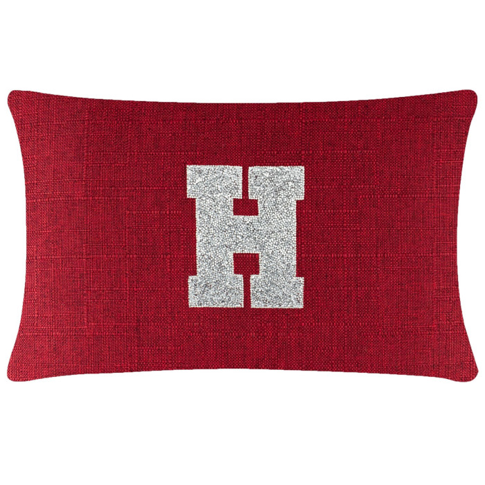 Rectangular red pillow with a textured surface and a large silver rhinestone monogram "H" in the center.