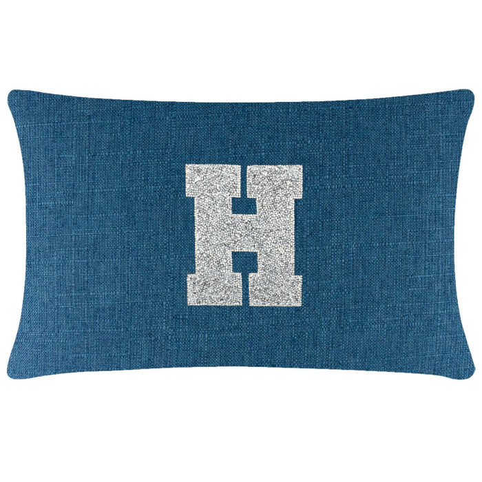 Rectangular pillow in deep blue fabric with a textured weave featuring a silver rhinestone letter "H" in the center.