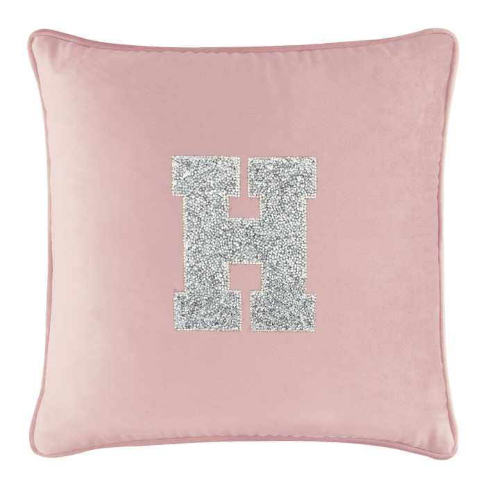 Blush velvet pillow with a large silver rhinestone letter "H" in the center and a soft plush texture.