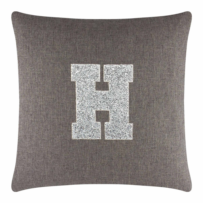 Square brown pillow with a textured fabric featuring a large silver rhinestone monogram "H" in the center.