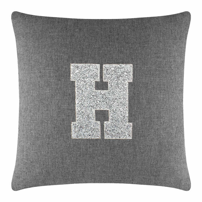 Gray linen pillow with a large rhinestone-embellished letter "H" in the center.