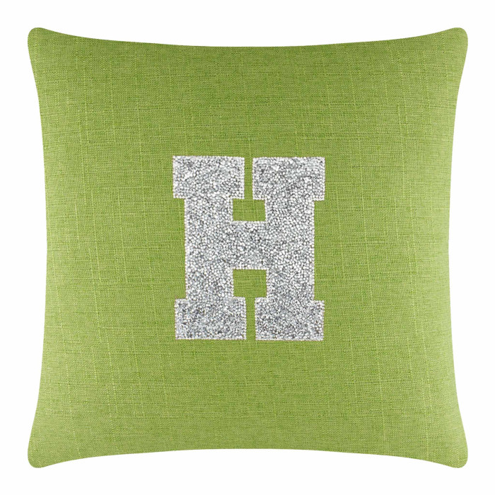 Lime green textured pillow with a large silver rhinestone letter "H" in the center.