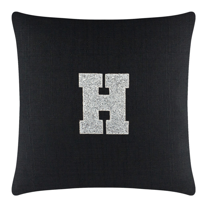 Black textured pillow featuring a large rhinestone monogram letter "H" in silver on the front.