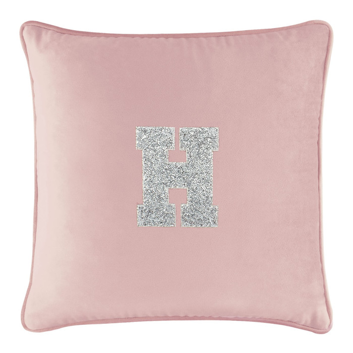 Blush velvet pillow with a silver rhinestone monogram "H" in the center and a soft plush texture.