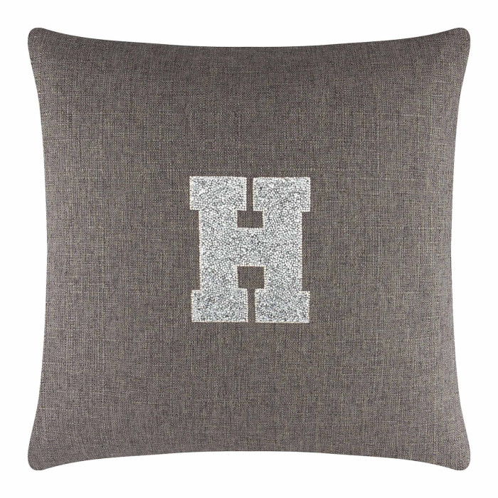 Square brown pillow with a textured fabric featuring a large silver rhinestone monogram "H" in the center.