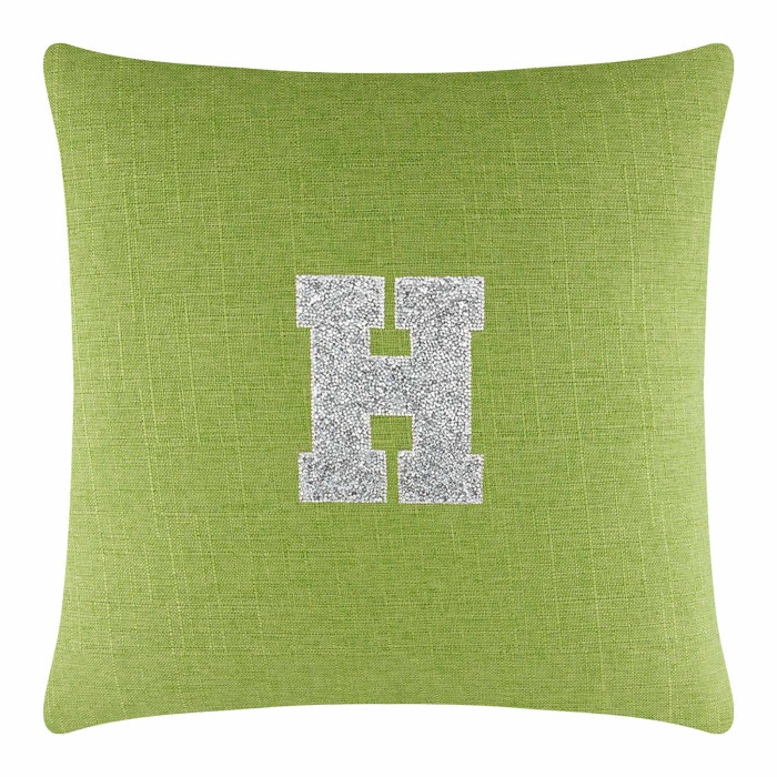 Lime green square pillow with a textured fabric featuring a large silver rhinestone monogram letter "H" in the center.
