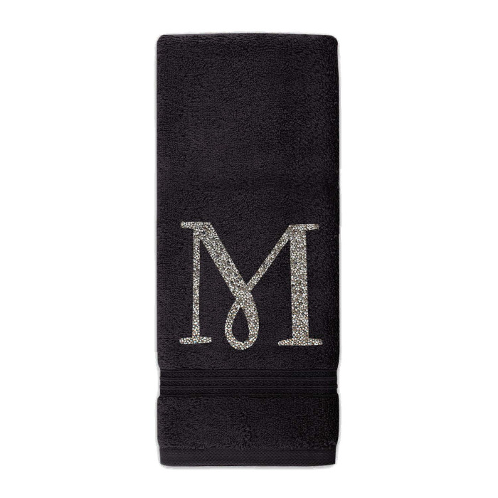 Black cotton terry hand towel with a sparkling rhinestone monogram "M" in silver featuring a textured finish and decorative trim.