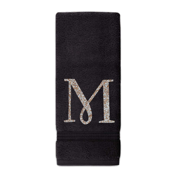 Black plush cotton terry hand towel with a sparkling rhinestone monogram "M" in silver and gold embellishments.