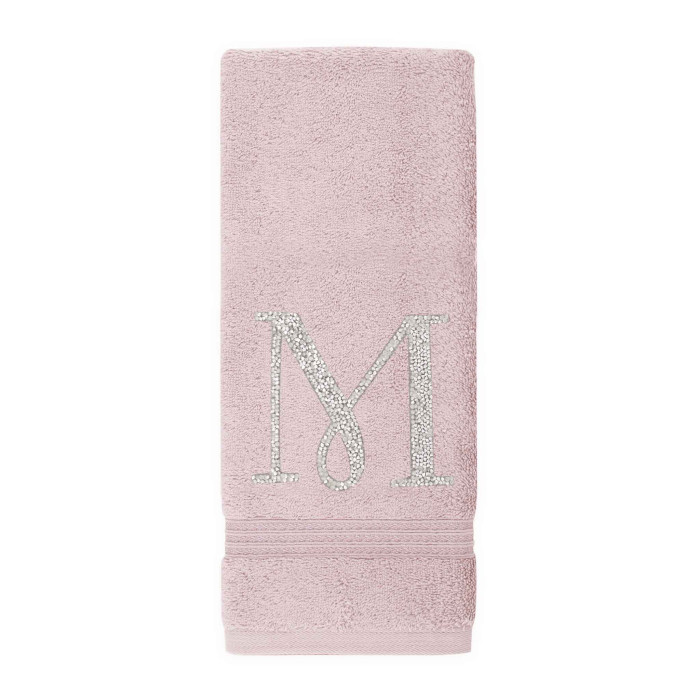 Pink cotton terry hand towel with a silver rhinestone monogram "M" and a textured band at the bottom.