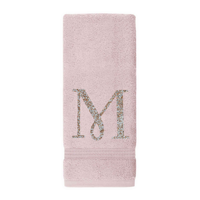 Plush pink cotton terry hand towel with a sparkling rhinestone monogram "M" and decorative stripes at the bottom.