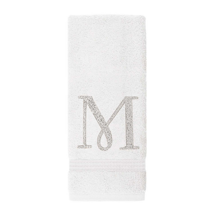 White cotton terry hand towel with a rhinestone monogram "M" and a textured border at the bottom.