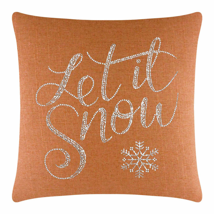 Orange textured pillow featuring silver rhinestone lettering "Let it Snow" and a snowflake design.