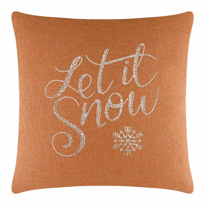 Square orange pillow with a textured fabric featuring silver glass rhinestones forming the phrase "Let it Snow" and a snowflake design.