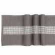 Black table runner with a textured finish and a central band of glass rhinestones arranged in a straight line. Black table runner with a textured finish and a central band of glass rhinestones arranged in a straight line.
