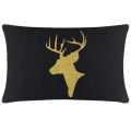 Green velvet pillow featuring a gold glitter reindeer silhouette with antlers on a smooth surface. Green velvet pillow featuring a gold glitter reindeer silhouette with antlers on a smooth surface.
