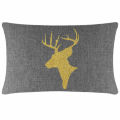 Green velvet pillow featuring a gold glitter reindeer silhouette with antlers on a smooth surface. Green velvet pillow featuring a gold glitter reindeer silhouette with antlers on a smooth surface.