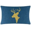 Green velvet pillow featuring a gold glitter reindeer silhouette with antlers on a smooth surface.
