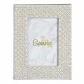 Silver picture frame with a pearl and glass rhinestone border showcasing a marble-patterned background inside.