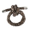 Silver wire napkin ring shaped as a knot embellished with rhinestones and featuring smooth metallic ends. Silver wire napkin ring shaped as a knot embellished with rhinestones and featuring smooth metallic ends.
