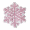 Snowflake-shaped pillow with pink glittery design and silver accents featuring a soft velvet texture on the back. Snowflake-shaped pillow with pink glittery design and silver accents featuring a soft velvet texture on the back.