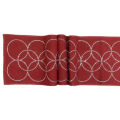 Black table runner with overlapping circles made of glass rhinestones on a textured fabric surface. Black table runner with overlapping circles made of glass rhinestones on a textured fabric surface.