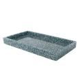 Black rectangular tray with a textured finish holding white napkins featuring a gold geometric border design. Black rectangular tray with a textured finish holding white napkins featuring a gold geometric border design.